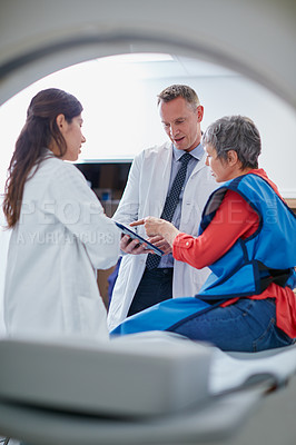 Buy stock photo Shot of a mature woman talking with doctors before and MRI scan