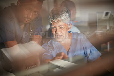 Buy stock photo Cropped shot of doctors working late into the night