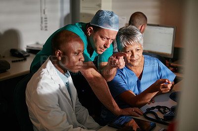 Buy stock photo Cropped shot of doctors working late into the night