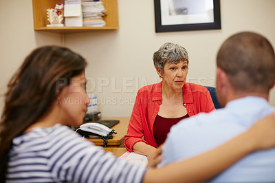 Buy stock photo Rearview shot of a couple sitting in a meeting with their financial advisor