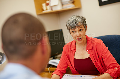 Buy stock photo Rearview shot of a man in a meeting with his financial advisor