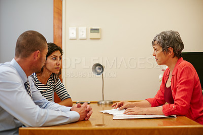 Buy stock photo Cropped shot of a couple sitting in a meeting with their financial advisor