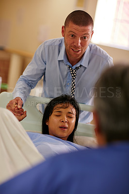 Buy stock photo Shot of a husband supporting his wife through a painful labor