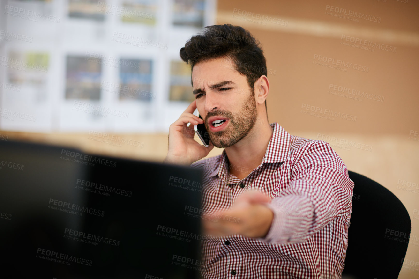 Buy stock photo Shot of a businessman using his cellphone while sitting at his desk