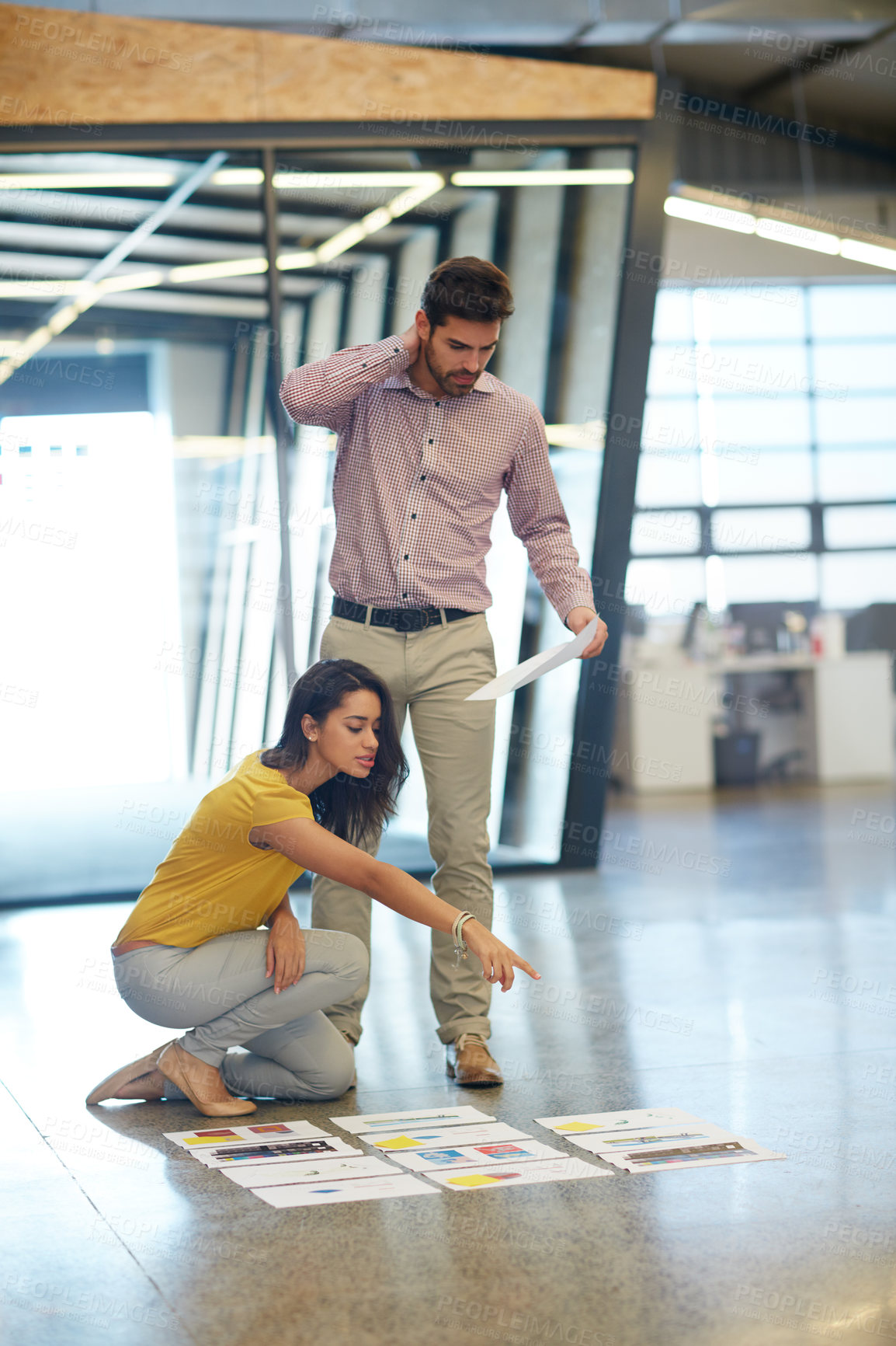 Buy stock photo Full length shot of two businesspeople looking over some paperwork