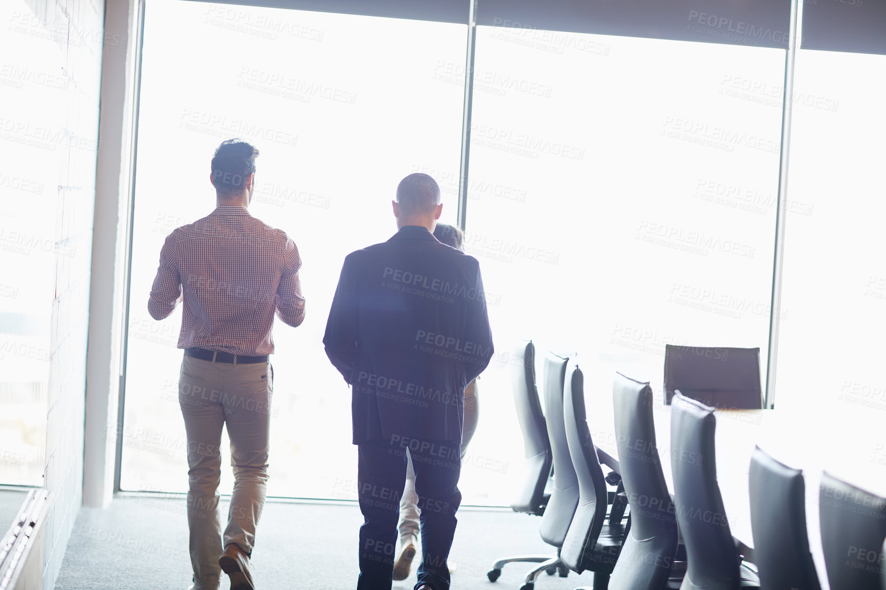 Buy stock photo Shot of three businesspeople walking into the boardroom