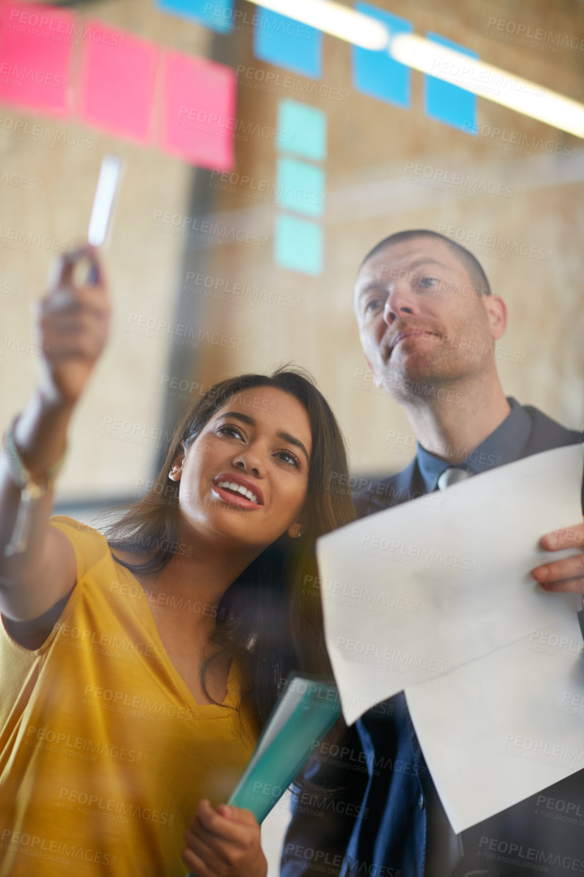 Buy stock photo Cropped shot of two businesspeople working in the office