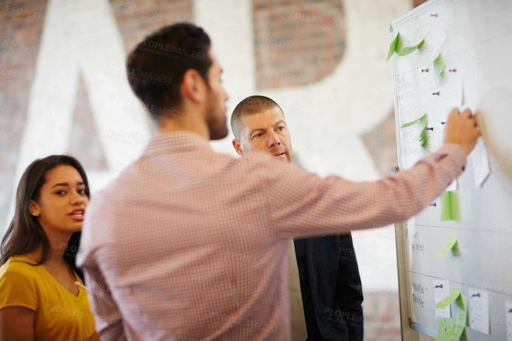 Buy stock photo Cropped shot of three businesspeople working in the office