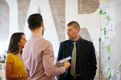 Buy stock photo Cropped shot of three businesspeople working in the office