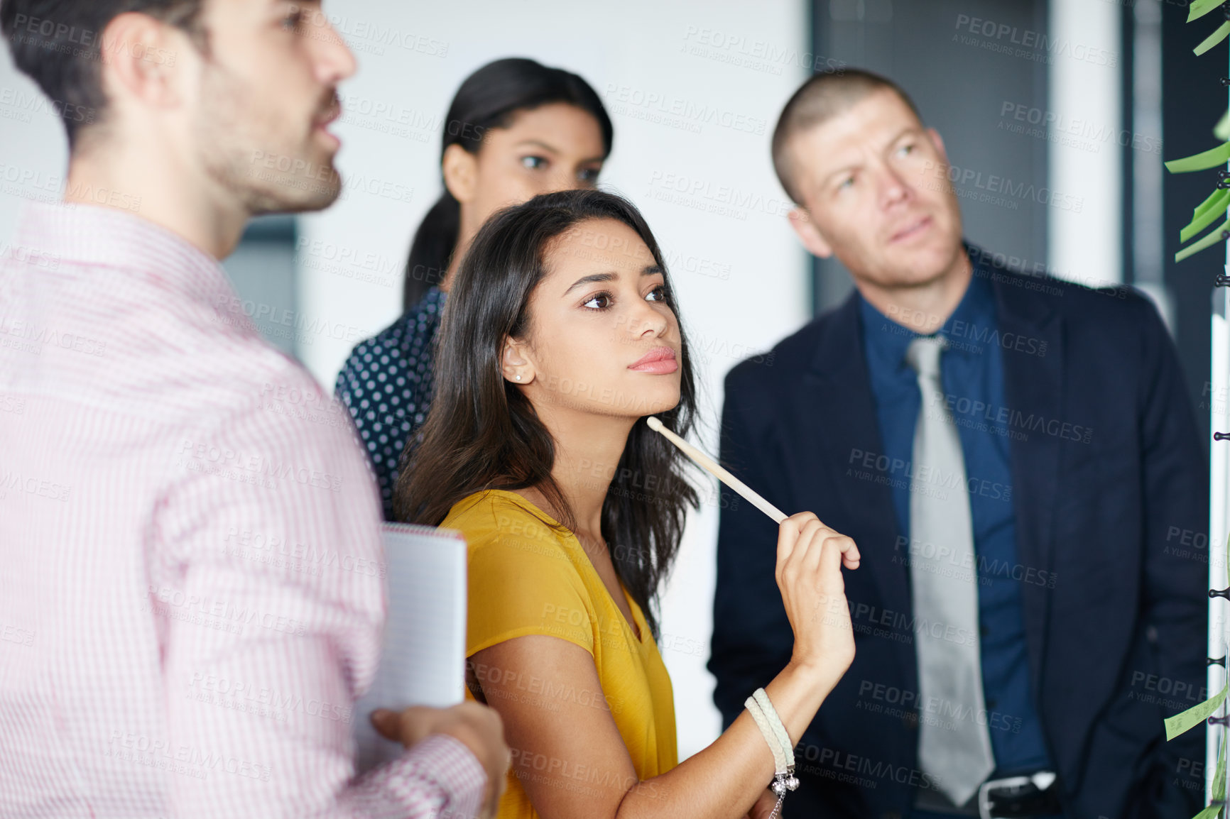 Buy stock photo Cropped shot of four businesspeople working in the office