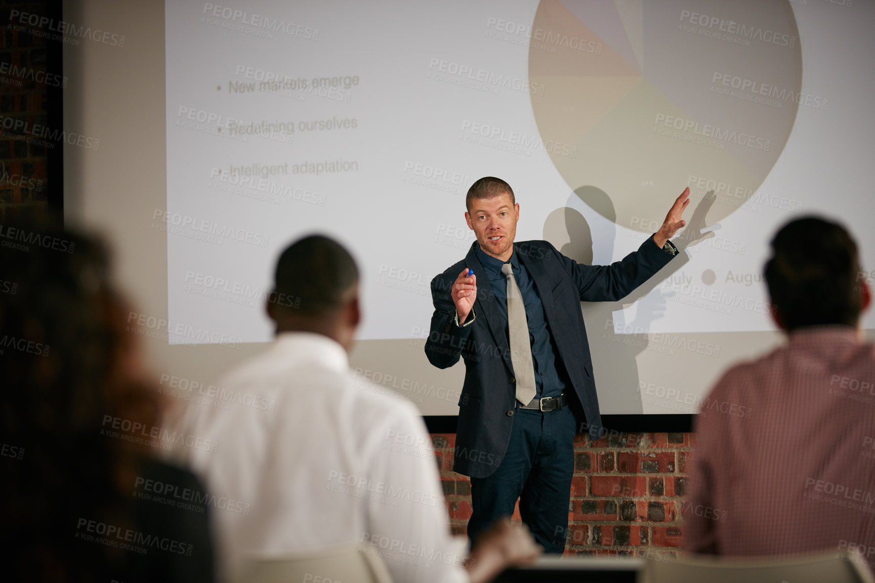 Buy stock photo Shot of a businessman giving a presentation to his colleagues