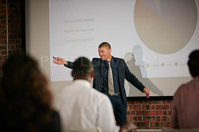 Buy stock photo Shot of a businessman giving a presentation to his colleagues