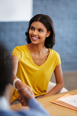 Buy stock photo Cropped shot of two businesspeople shaking hands in the office