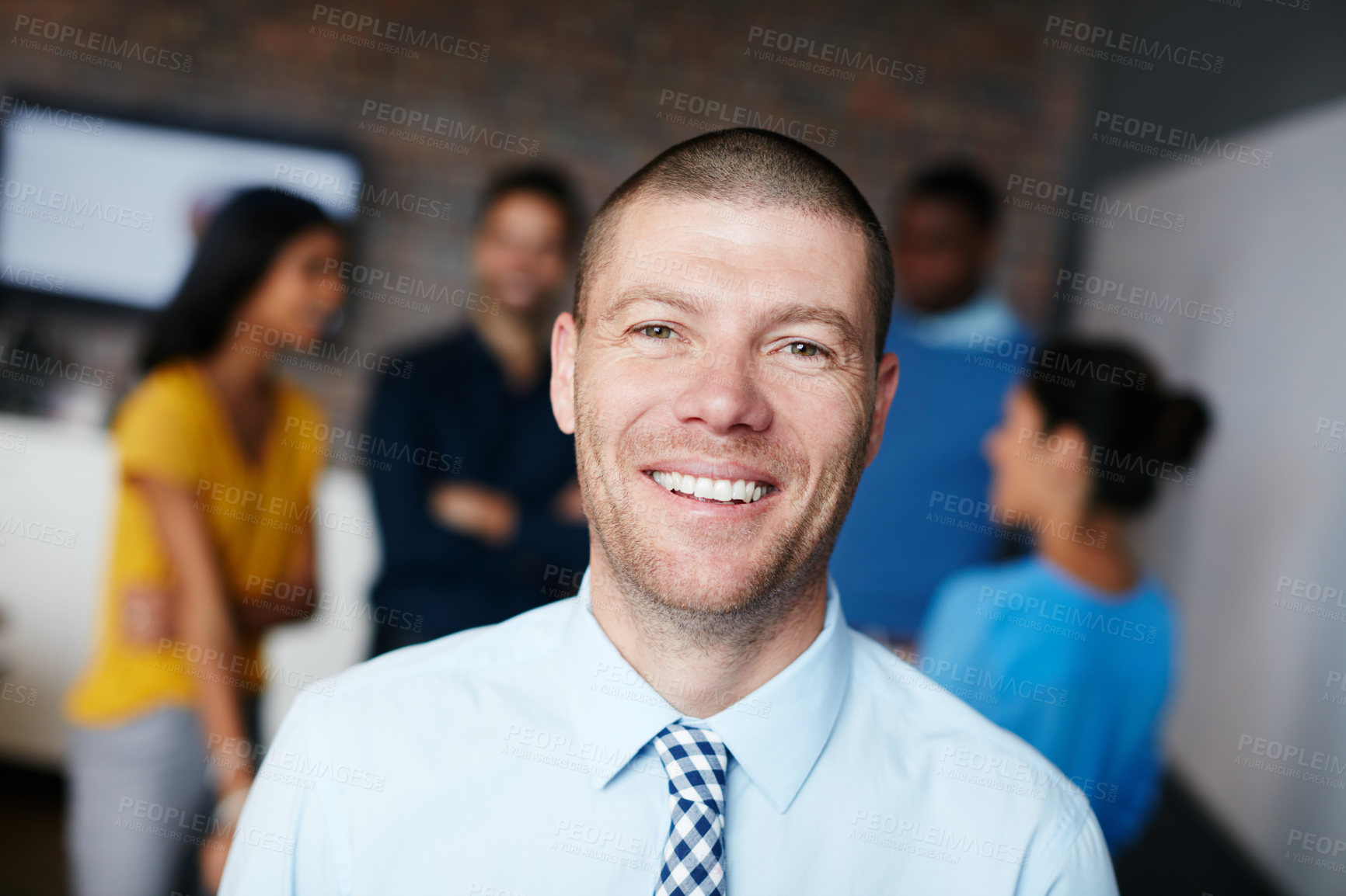 Buy stock photo Cropped portrait of a businessman standing in the workplace with his colleagues in the background