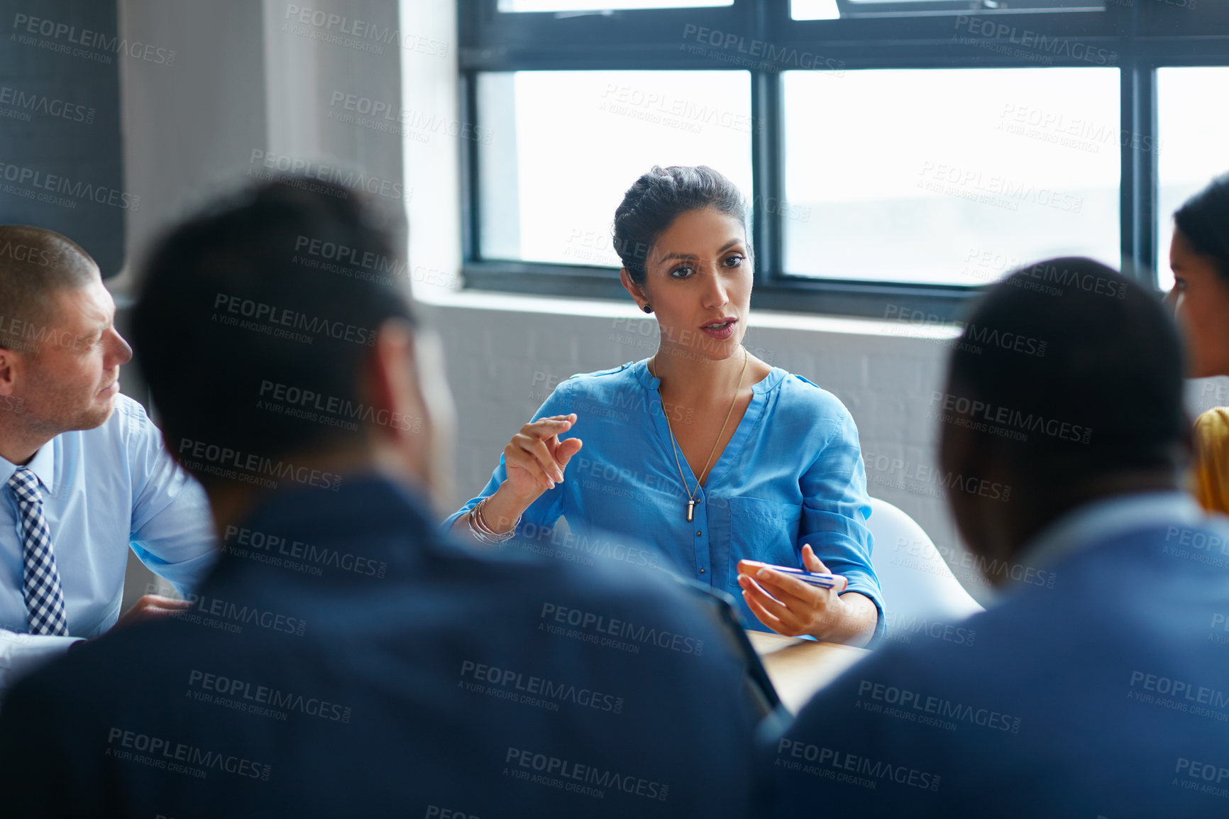 Buy stock photo Cropped shot of a group of businesspeople in the boardroom