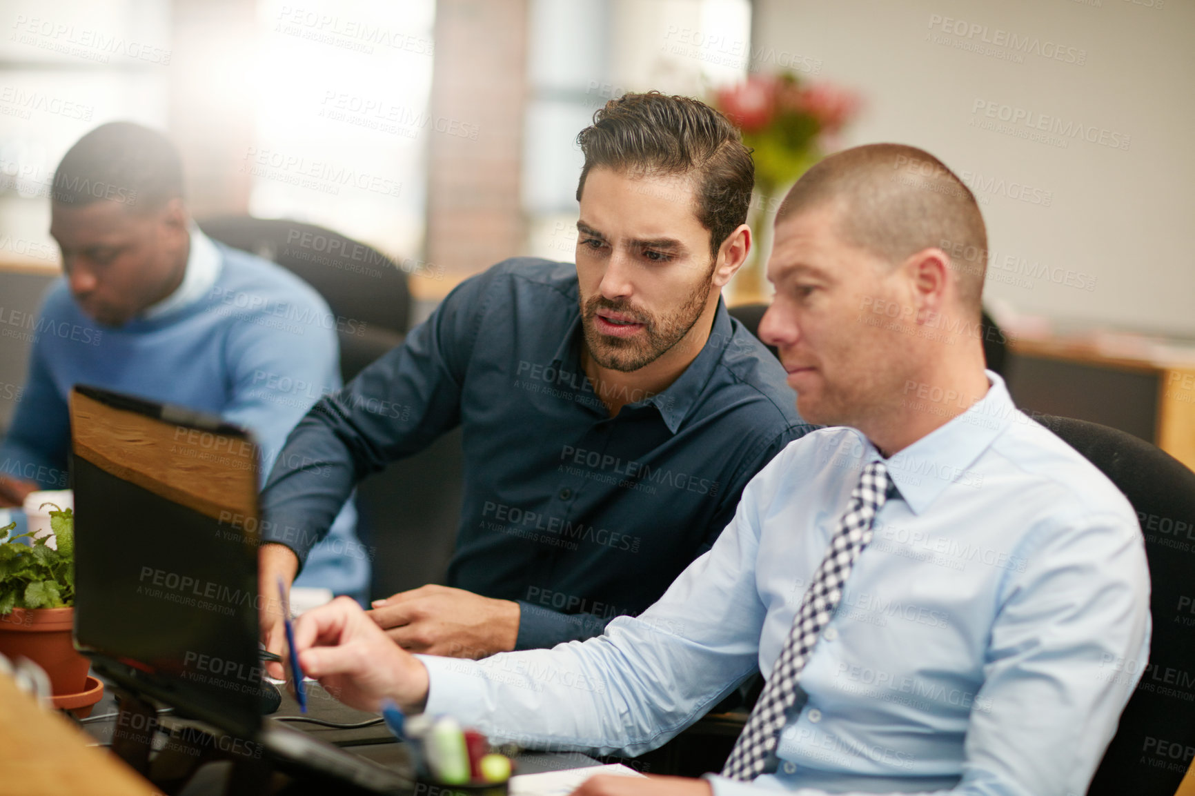 Buy stock photo Cropped shot of three businessmen working in the office