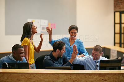 Buy stock photo Cropped shot of a group of creative professionals cheering in the office