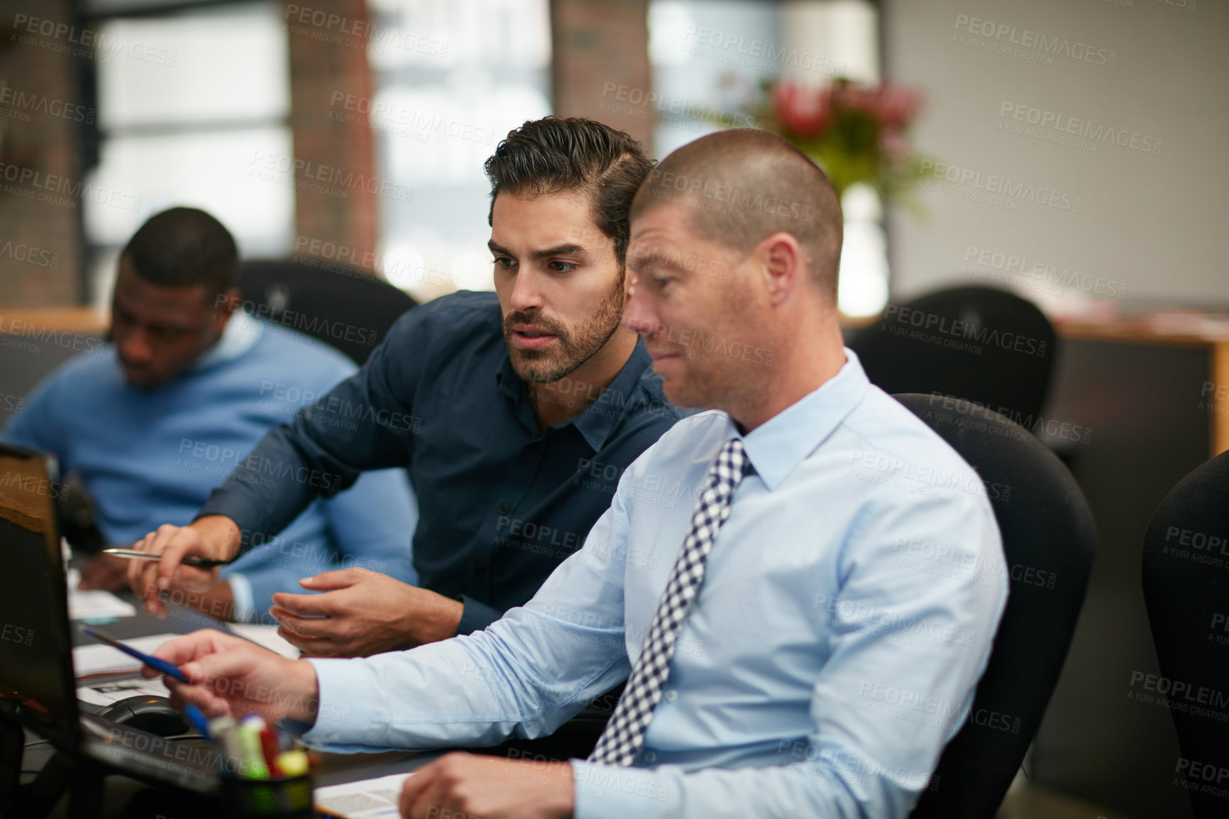 Buy stock photo Cropped shot of three businessmen working in the office