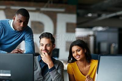 Buy stock photo Cropped shot of three businesspeople working in the office