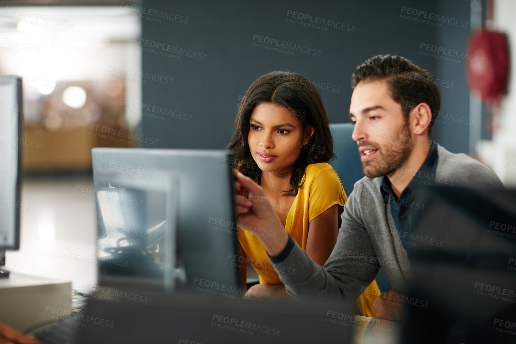 Buy stock photo Cropped shot of two businesspeople working in the office