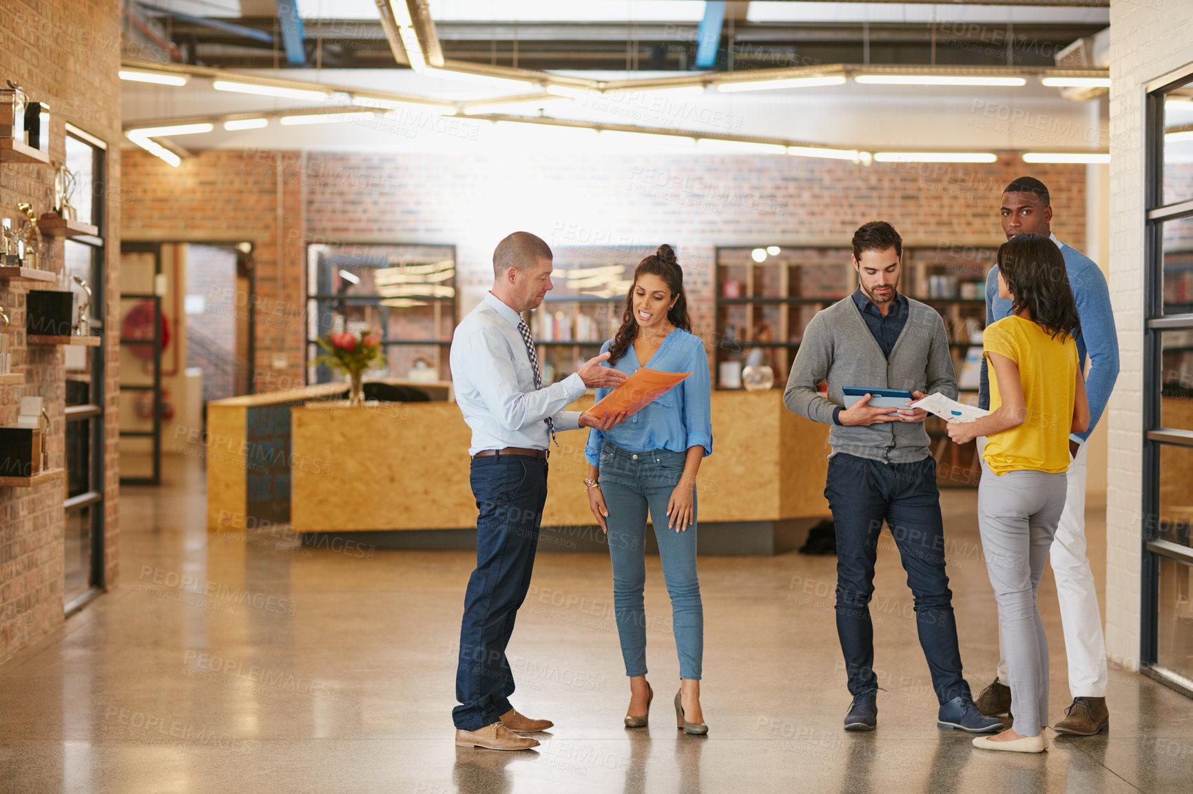 Buy stock photo Full length shot of businesspeople talking while standing around in the office