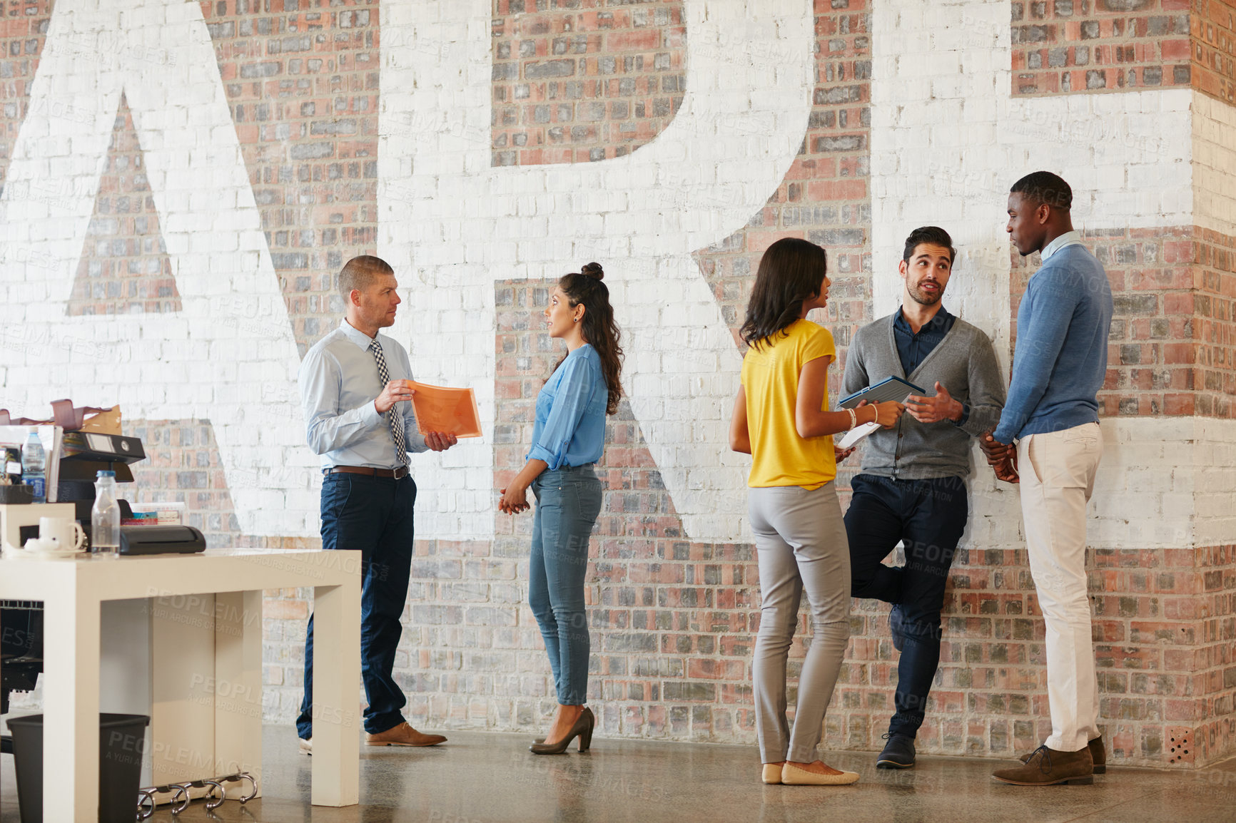 Buy stock photo Full length shot of businesspeople talking while standing around in the office