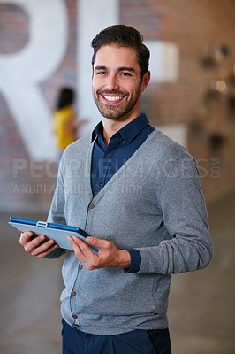Buy stock photo Cropped portrait of a young man standing with a tablet in the office