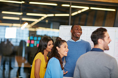 Buy stock photo Cropped shot of a group of businesspeople talking in the boardroom