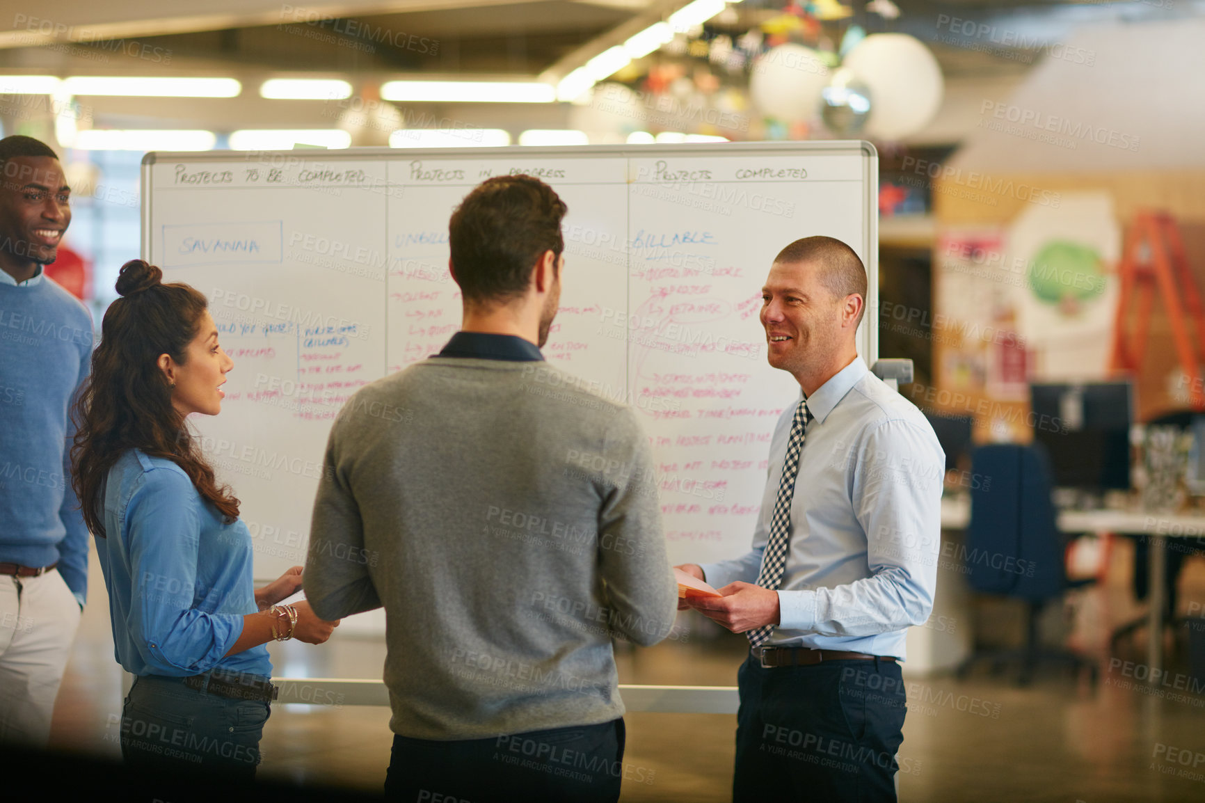 Buy stock photo Cropped shot of a group of businesspeople talking in the boardroom