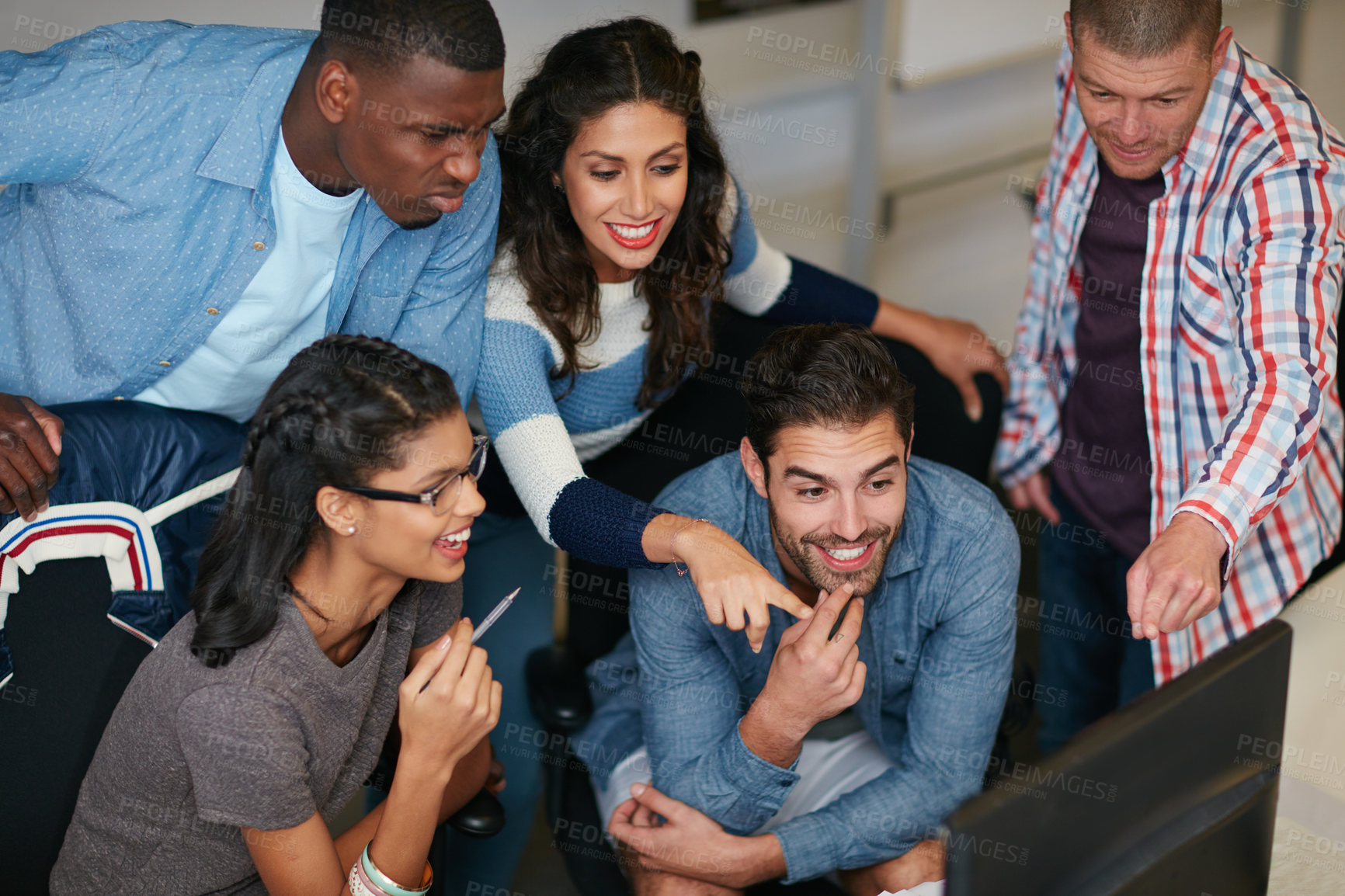 Buy stock photo Shot of team of colleagues using a computer together in a modern office