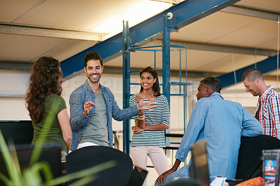 Buy stock photo Shot of a team of colleagues having an informal meeting in a modern office