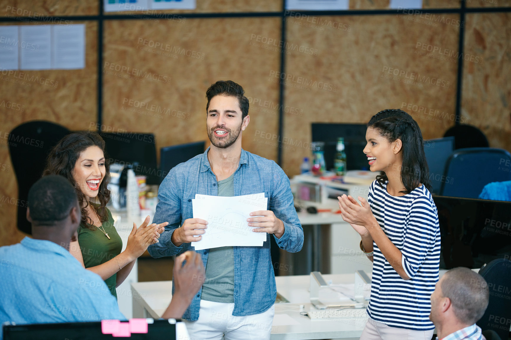 Buy stock photo Shot of a team of colleagues having an informal meeting in a modern office