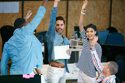 Buy stock photo Shot of a team of colleagues celebrating in a modern office