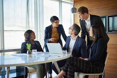 Buy stock photo Shot of a group of corporate businesspeople working in the boardroom