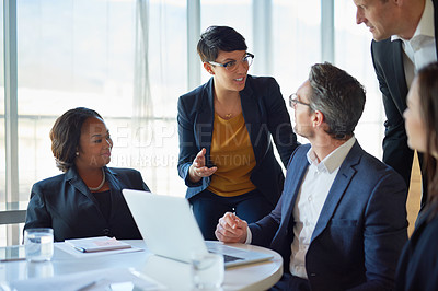 Buy stock photo Diversity, colleagues with laptop and at desk in a boardroom of their modern workplace. Collaboration or teamwork, support or brainstorming for help and coworkers working together on a project