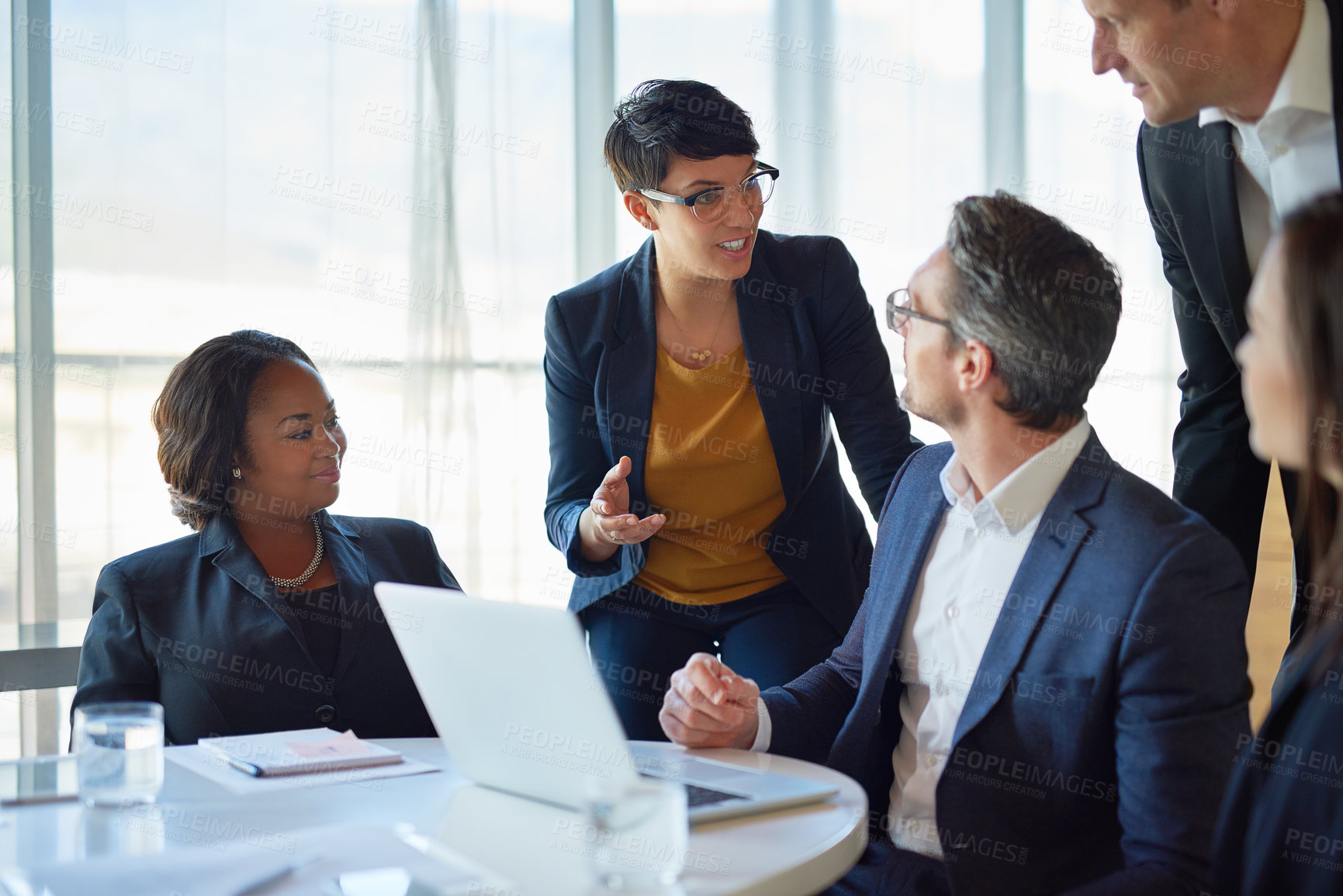 Buy stock photo Diversity, colleagues with laptop and at desk in a boardroom of their modern workplace. Collaboration or teamwork, support or brainstorming for help and coworkers working together on a project