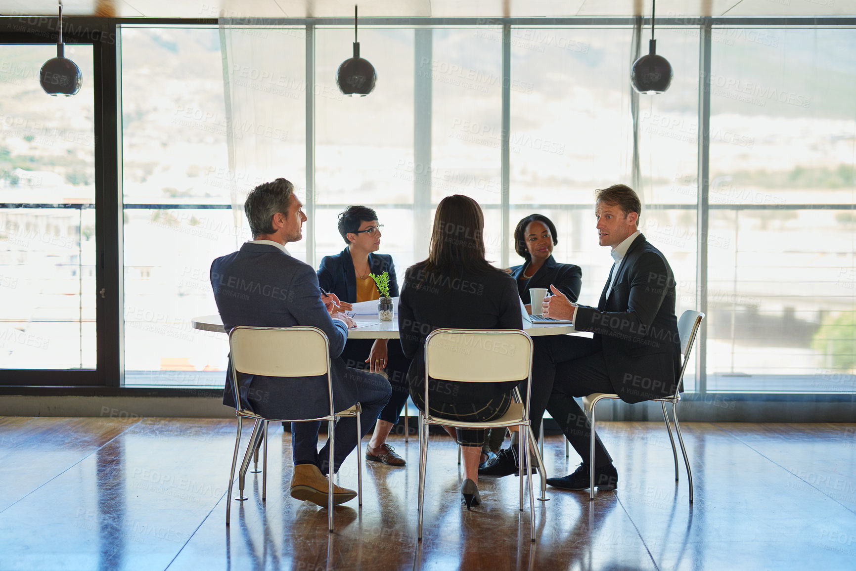 Buy stock photo Shot of a group of corporate businesspeople working in the boardroom
