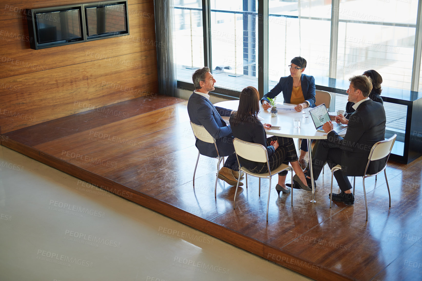 Buy stock photo Shot of a group of corporate businesspeople working in the boardroom