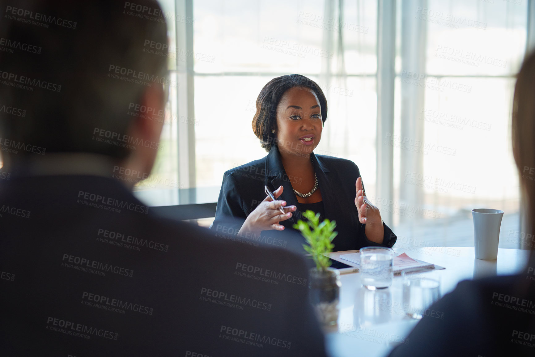 Buy stock photo Shot of three corporate businesspeople working in the boardroom