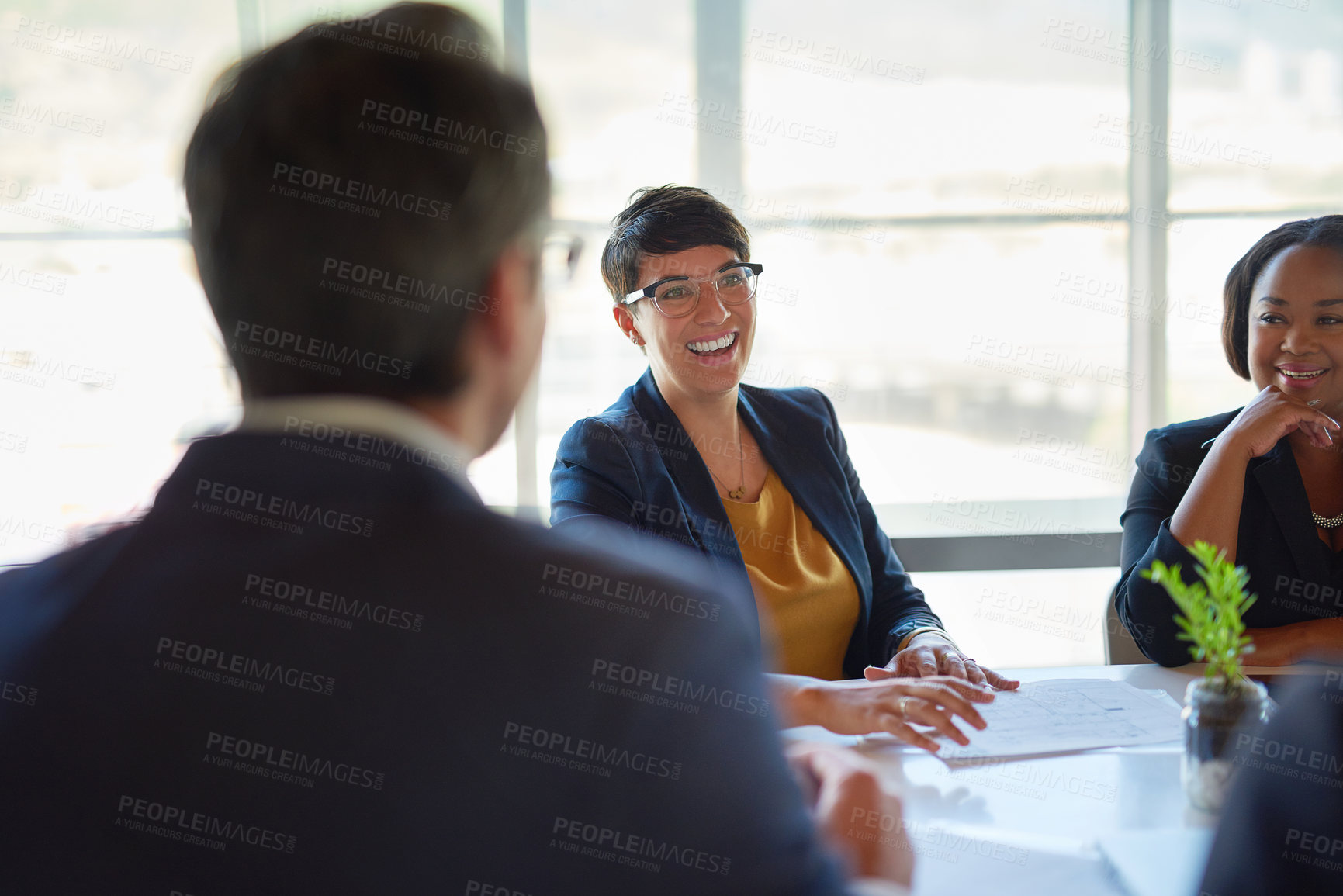 Buy stock photo Shot of four corporate businesspeople working in the boardroom