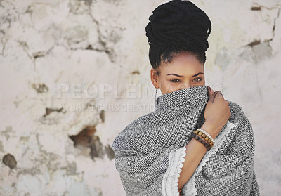 Buy stock photo Cropped portrait of an attractive young woman covering her mouth with her poncho