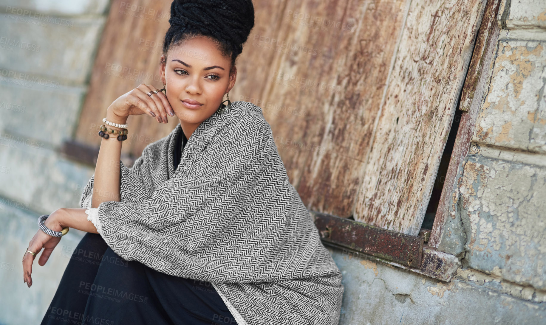 Buy stock photo Cropped shot of a fashionable young woman sitting outside