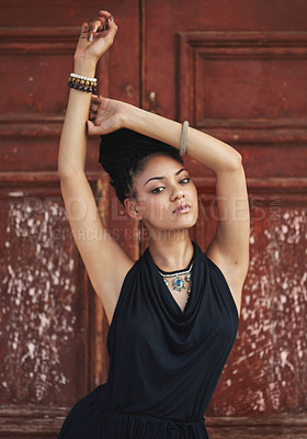 Buy stock photo Portrait, urban or woman with fashion, dreadlocks or bangles by wall, door in urban town alone. Stylist, hairdresser and proud natural model with confidence, dress or necklace for culture in Jamaica