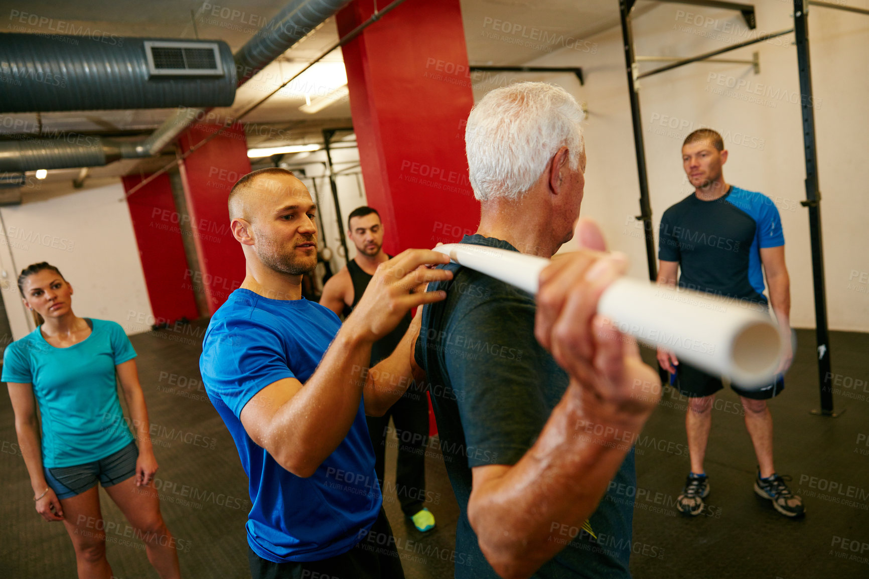 Buy stock photo Shot of a senior man doing pvc pipe exercises with the assistance of his trainer