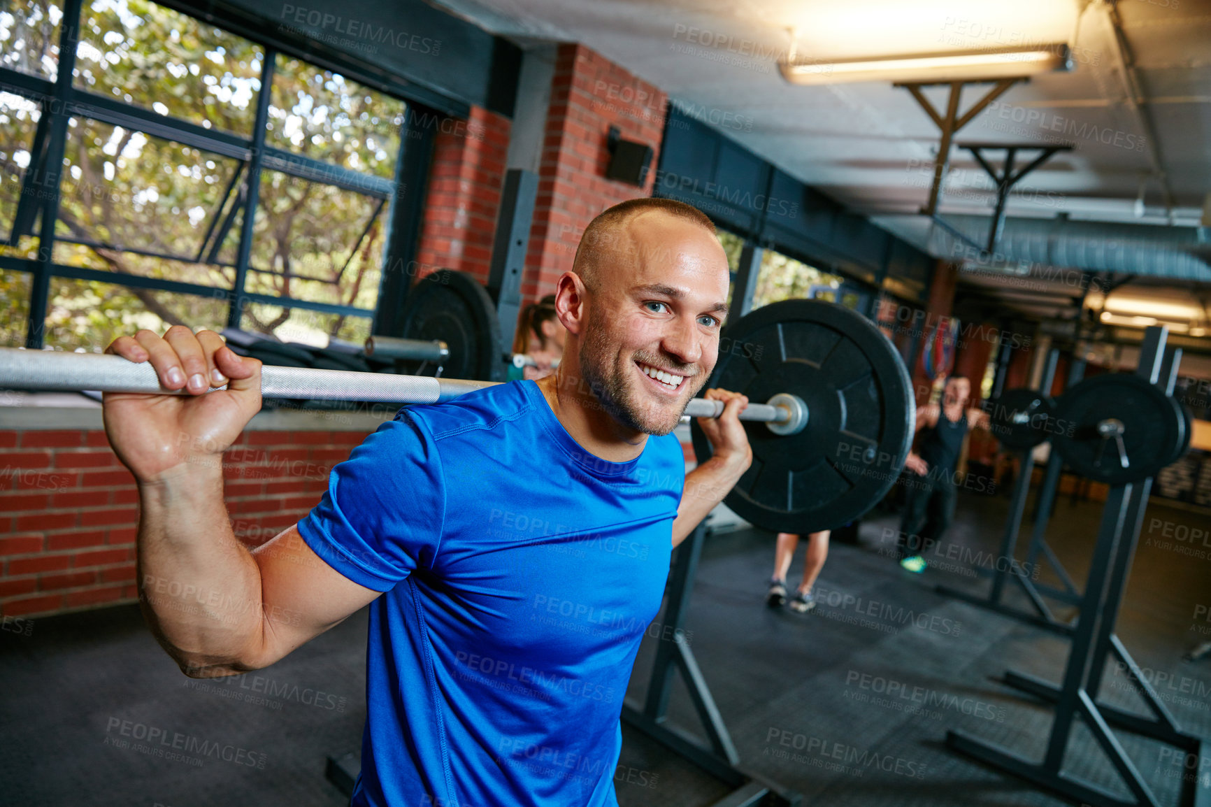 Buy stock photo Shot of a man doing weight training at the gym