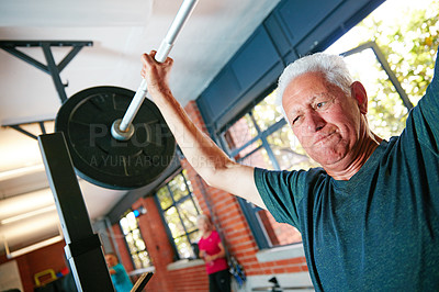 Buy stock photo Shot of a senior man doing weight training at the gym