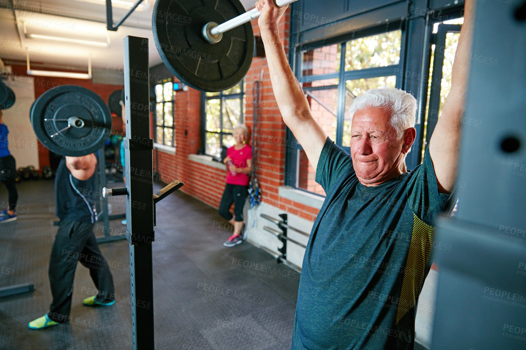 Buy stock photo Shot of a senior man doing weight training at the gym