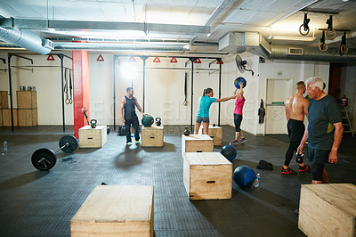 Buy stock photo Shot of a group of people working out at the gym