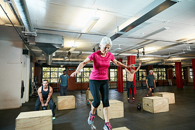 Buy stock photo Shot of a senior woman box jumping at the gym
