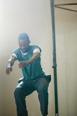 Buy stock photo Shot of a young man working out at the gym
